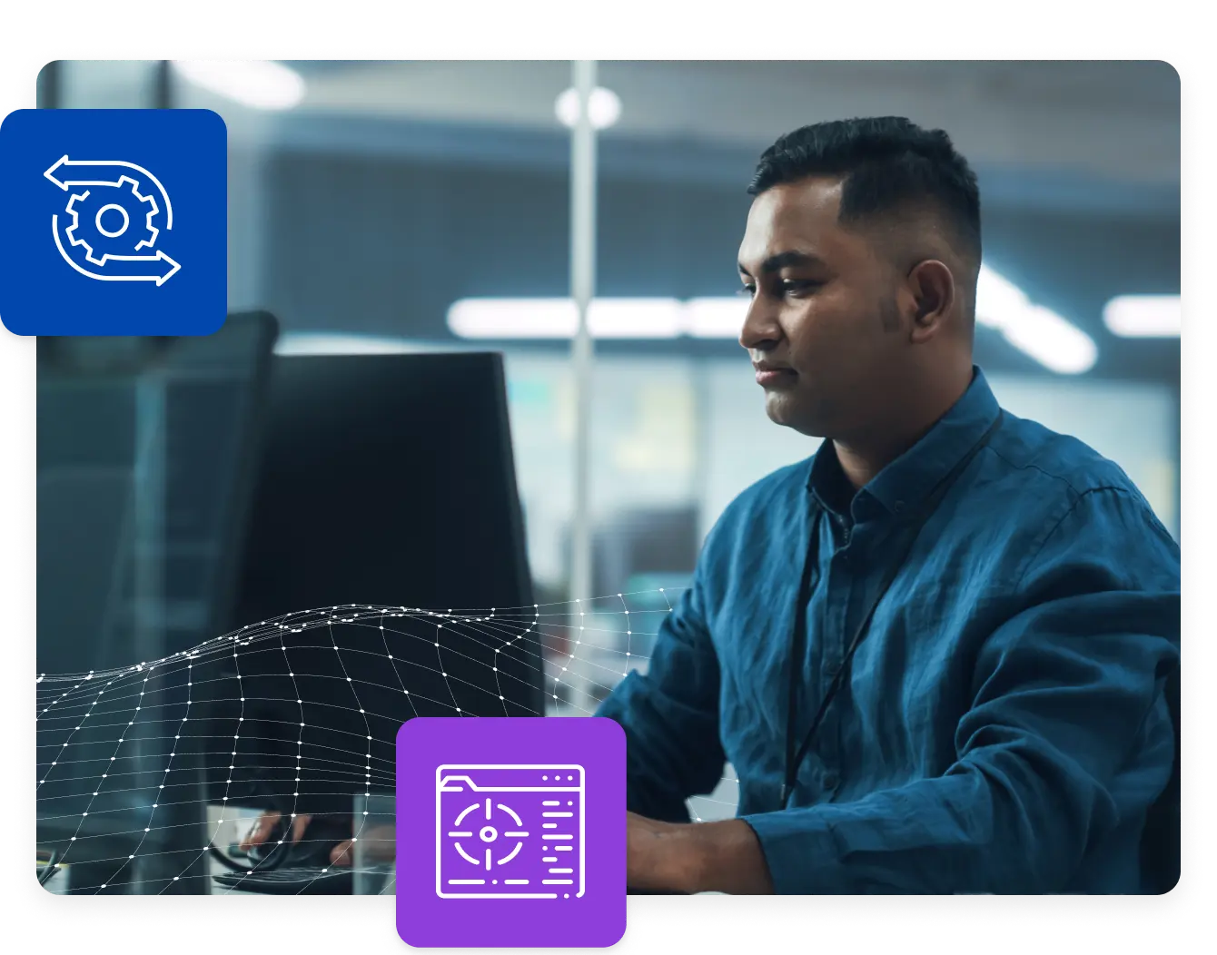 Stock imagery of a man sitting at a computer in the office
